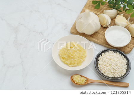 Garlic Koji and ingredients (garlic, rice koji, salt) | White marble background Garlic Koji and ingredients (garlic, rice koji, salt) | White marble background 123805814