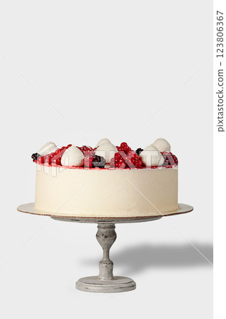 Cake decorated with fresh berries and cream 123806367