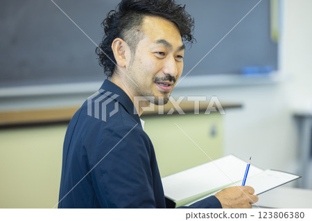 Teachers holding parent-teacher conferences Teachers holding parent-teacher conferences 123806380