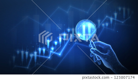 Hand with a magnifying glass and market charts. Market analysis, financial forecast, business growth. 123807174