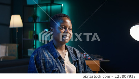 Portrait of happy woman sitting at home office desk, preparing to solve tasks on laptop. Smiling freelancer in front of digital device, doing email communication in living room, camera B Portrait of happy woman sitting at home office desk, preparing to solve tasks on laptop. Smiling freelancer in front of digital device, doing email communication in living room, camera B 123807932