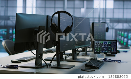 Artificial intelligence applications used in data center workplace to maintain company network equipment, handheld camera shot. AI programs used in server room to ensure optimal system performance 123808053