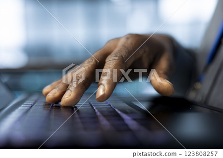 Technician in data center typing on laptop keyboard, developing disaster recovery plans. Close up of worker in server hub testing failover scenarios using notebook, protecting data during disruptions 123808257