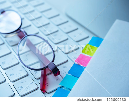 Documents, keyboard and glasses on a table 123809280