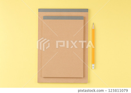 Sketchbook with a pencil on a yellow background. Sketchbook with a pencil on a yellow background. 123811079