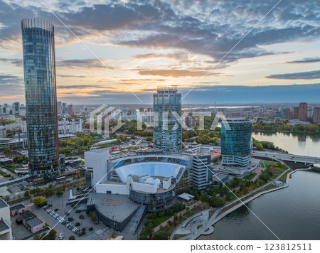 Yekaterinburg city and pond aerial panoramic view at summer or early autumn sunset. Night city in the early autumn or summer. Yekaterinburg city and pond aerial panoramic view at summer or early autumn sunset. Night city in the early autumn or summer. 123812511