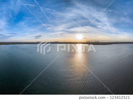 Autumn forest on lake shore at sunset and city on horizon, auerial view Autumn forest on lake shore at sunset and city on horizon, auerial view 123812521