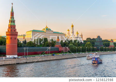 View of Kremlin with Vodovzvodnaya tower, Grand Kremlin Palace from repaired Bolshoy Kamenny Bridge in Moscow city on sunny summer day. Cruise ship sails on the Moscow river View of Kremlin with Vodovzvodnaya tower, Grand Kremlin Palace from repaired Bolshoy Kamenny Bridge in Moscow city on sunny summer day. Cruise ship sails on the Moscow river 123812598