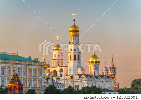 Ivan the Great Bell Tower, with Assumption Belfry on the right in Moscow Kremlin. Blue sky background with sunbeams 123812601