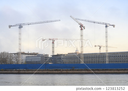 Cranes in the early morning in the fog at a construction site in St. Petersburg, Russia, in autumn 123813252