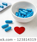 Medical capsules and pills arranged on a clean surface, various shapes and sizes of medicine in vibrant colors 123814319