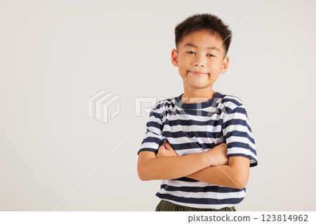Asian happy portrait cute young kid boy smiling confidence with arms crossed studio shot isolated on white background and copy space, primary children person lifestyle arm folded 123814962