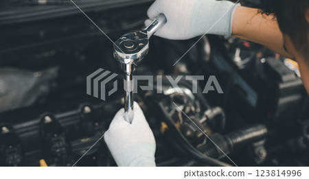 Service outdoor. Close up hands of auto mechanic man working on car engine using wrench to repair and maintenance, broken car care check and fixed the problem and services insurance 123814996