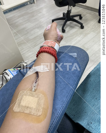 Blood Donation Process: A Woman Arm with a Needle Drawing Blood Blood Donation Process: A Woman Arm with a Needle Drawing Blood 123815846
