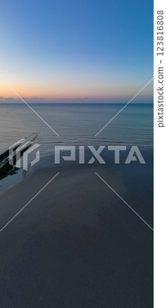 A Tranquil Sunset Over Calm Waters with a Beautiful Sandy Beach Area to Relax and Enjoy A Tranquil Sunset Over Calm Waters with a Beautiful Sandy Beach Area to Relax and Enjoy 123816808
