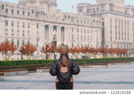 woman traveler visiting in Shanghai, China. Happy Female Tourist sightseeing Shanghai view in The Bund of Shanghai in Autumn season. landmark and popular for tourism attractions. Travel and Vacation 123818289
