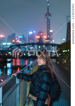 woman traveler visiting in Shanghai, China. Happy Female Tourist sightseeing Oriental Pearl Tower and Waibaidu Bridge view. landmark and popular for tourism attractions. Travel and vacation concept 123818301