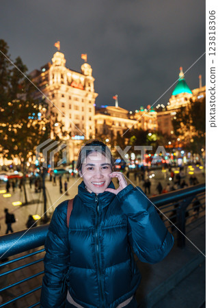 woman traveler visiting in Shanghai, China. Happy Female Tourist sightseeing Shanghai view in The Bund of Shanghai at night. landmark and popular for tourism attractions. Travel and Vacation concept woman traveler visiting in Shanghai, China. Happy Female Tourist sightseeing Shanghai view in The Bund of Shanghai at night. landmark and popular for tourism attractions. Travel and Vacation concept 123818306