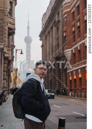 man traveler visiting in Shanghai, China. Happy male Tourist sightseeing Oriental Pearl Tower view in The Rock Bund of Shanghai. landmark and popular for tourism attractions. Travel and Vacation man traveler visiting in Shanghai, China. Happy male Tourist sightseeing Oriental Pearl Tower view in The Rock Bund of Shanghai. landmark and popular for tourism attractions. Travel and Vacation 123818325