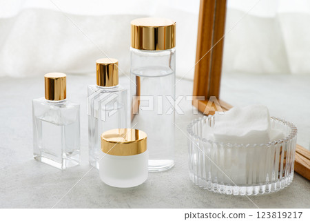 Glass cosmetic bottles and cotton pads 123819217
