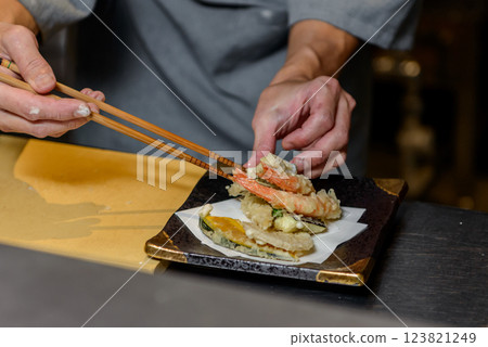 A chef arranging tempura A chef arranging tempura 123821249