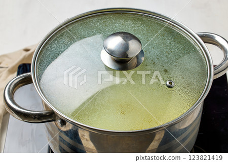 pot with a closed, dewy lid pot with a closed, dewy lid 123821419