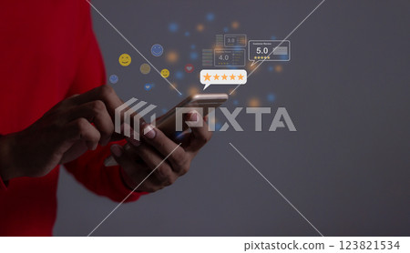 Young Man hand holding Smart Phone with five star to review and give 5 stars Young Man hand holding Smart Phone with five star to review and give 5 stars 123821534