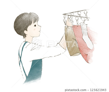 A woman hanging up the laundry A woman hanging up the laundry 123821943
