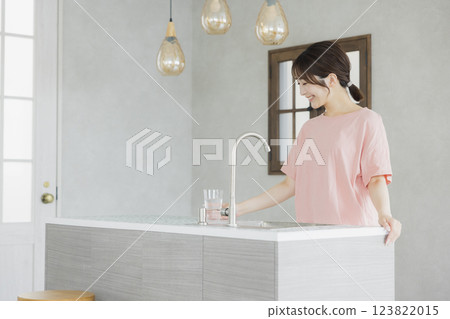 一個女人在廚房喝水 123822015