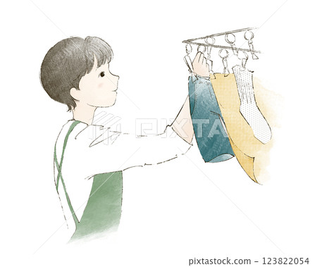 A woman hanging up the laundry A woman hanging up the laundry 123822054