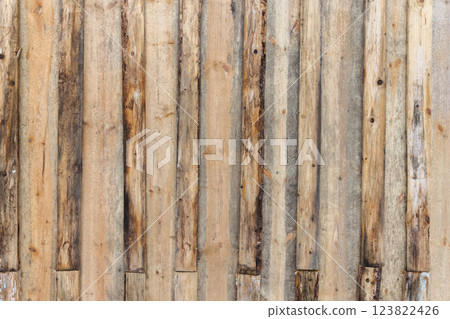 Weathered wooden surface comprised of vertical, worn wooden planks 123822426