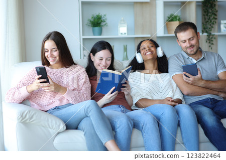 Four roommates or friends enjoying of different hobbies Four roommates or friends enjoying of different hobbies 123822464
