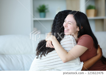 Happy asian woman hugging her friend at home 123822476