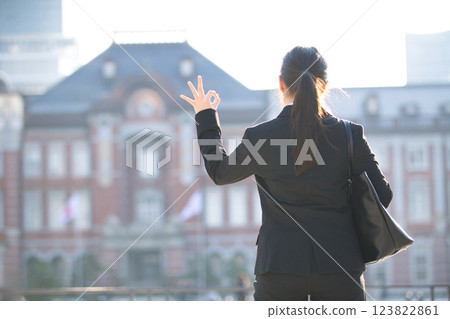 A young woman looking for a job walking through an office district 123822861