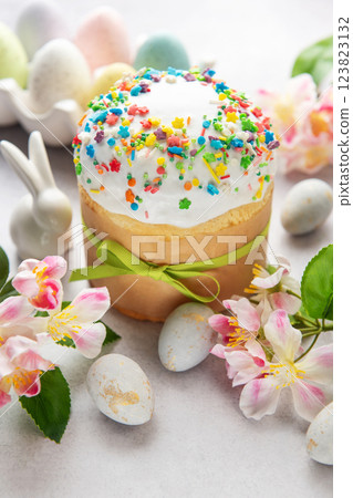 Delicious easter cake with colorful sprinkles, eggs, flowers and bunny celebrating spring festivities Delicious easter cake with colorful sprinkles, eggs, flowers and bunny celebrating spring festivities 123823132