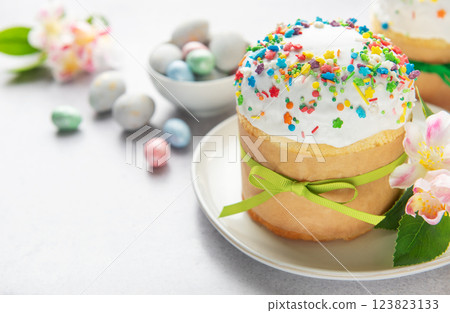 Delicious easter cake decorated with colorful sprinkles and green ribbon Delicious easter cake decorated with colorful sprinkles and green ribbon 123823133