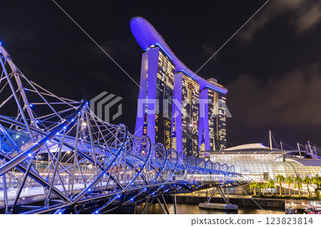 Night view of The Helix Bridge and the Marina Bay Sands Resort, Singapore, it's a pedestrian bridge linking the Marina Centre with Marina South. 123823814