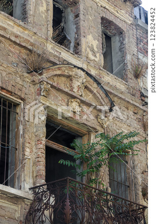 Old building facade showing decay and plant growth in Bucharest, Romania, reflecting the history and beauty of urban architecture Old building facade showing decay and plant growth in Bucharest, Romania, reflecting the history and beauty of urban architecture 123824452
