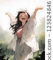 A woman happily spreading her arms in the rain 123824846