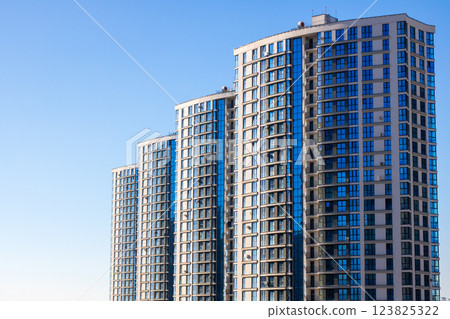 A series of tall skyscrapers standing against a clear blue sky A series of tall skyscrapers standing against a clear blue sky 123825322