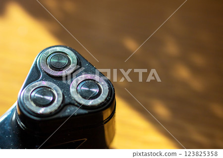 A detailed close up showcasing a shaver that has three razor blades A detailed close up showcasing a shaver that has three razor blades 123825358
