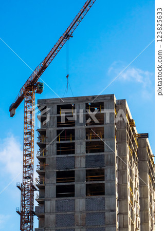 A busy construction site with cranes and a building in progress 123825633