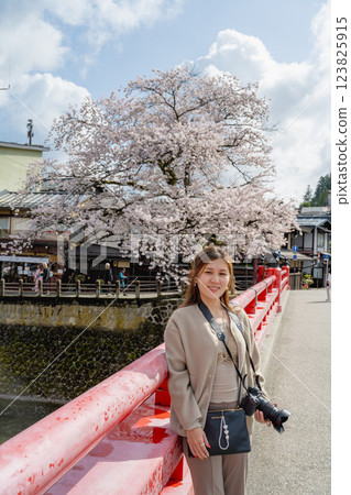 April 17, 2024. Japan's Gifu Prefecture Mountain District, female tourists and Sakura Hanaki. 123825915