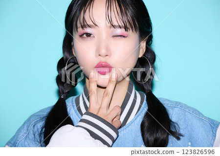 Casual portrait of a young woman in street fashion 123826596