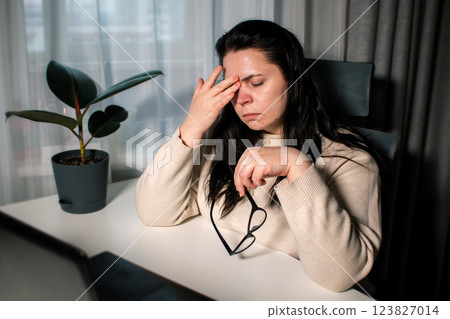 Tired business woman having fatigue and headache during work with computer. Female feeling stress and exhausted in office because of overwork Tired business woman having fatigue and headache during work with computer. Female feeling stress and exhausted in office because of overwork 123827014