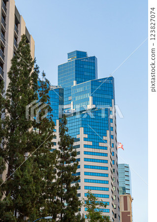 Modern skyscrapers stand tall under the golden evening light. 123827074