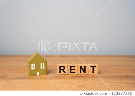 Real estate, apartment and housing rental concept. Miniature house and wooden blocks with inscription Rent 123827178