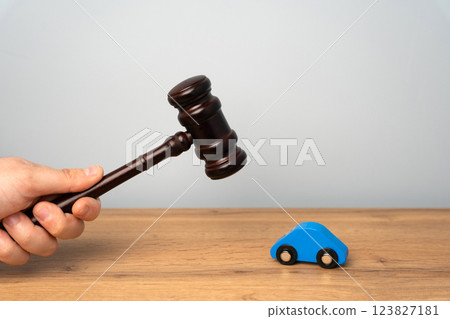 Judge's hammer and toy blue car. Traffic and driving rules concept. Auto accident, drunk driving, court of law, justice 123827181