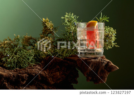 Refreshing hard seltzer with ice, grapefruit, and rosemary on an old snag. Refreshing hard seltzer with ice, grapefruit, and rosemary on an old snag. 123827197