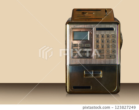 front view gold metal Mini ATM on gradient brown floor, cream wall background, technology, object, fashion, decor,  decoration, copy space 123827249